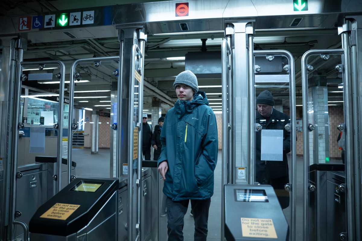 rider enters modern fare gates being tested by MTA