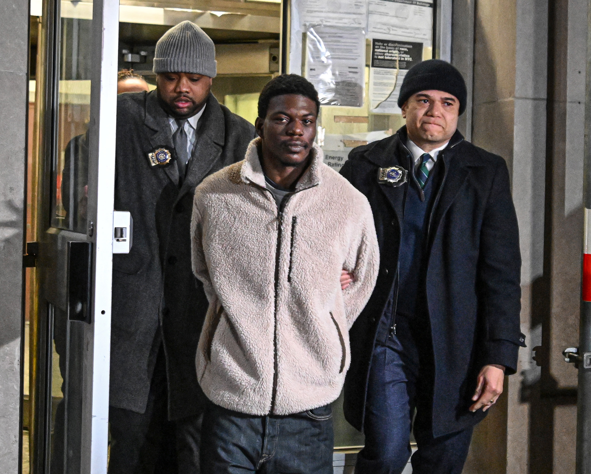 Suspect in Manhattan rape case escorted by detectives in handcuffs