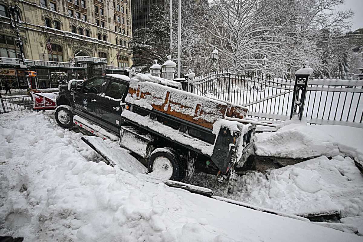 city snowplow caught in sinkhole during blizzard