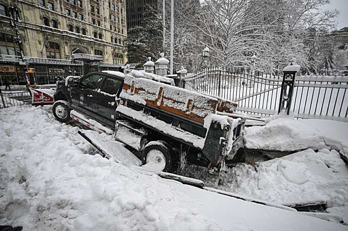 city snowplow caught in sinkhole during blizzard