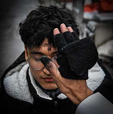 Priest administers ashes on Ash Wednesday to immigrant at Federal Plaza