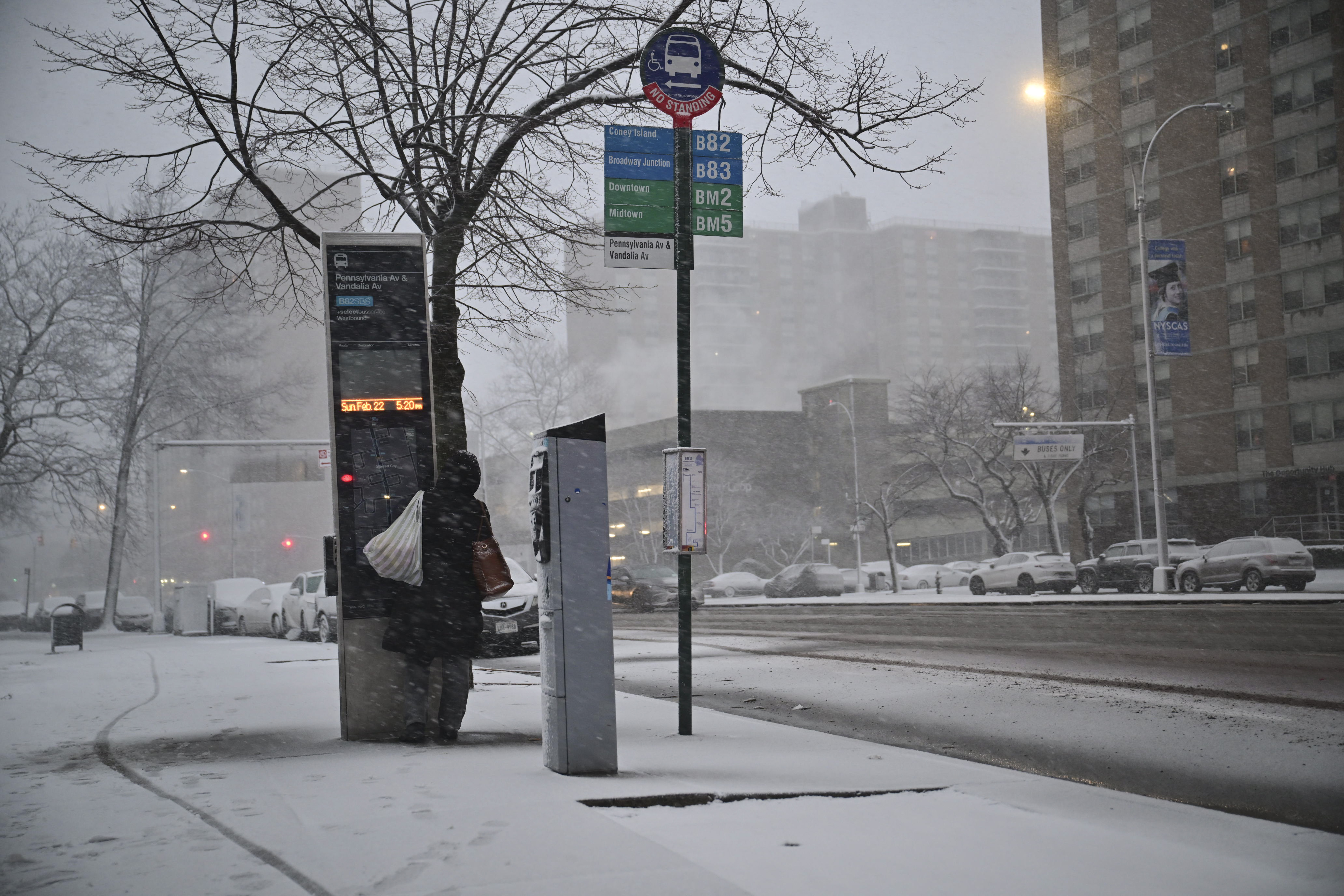 person waiting for buses in Brooklyn during blizzard