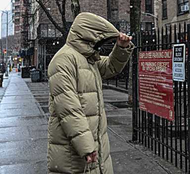 person walking outside in NYC wearing a winter coat