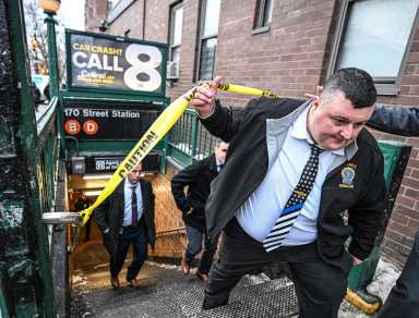 Police leave the scene of a shooting at the 170th Street B/D subway station.