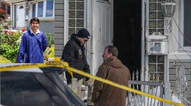 Officers outside the Chakraborty family home on Jan. 26 following the shooting of 22-year-old Jabez