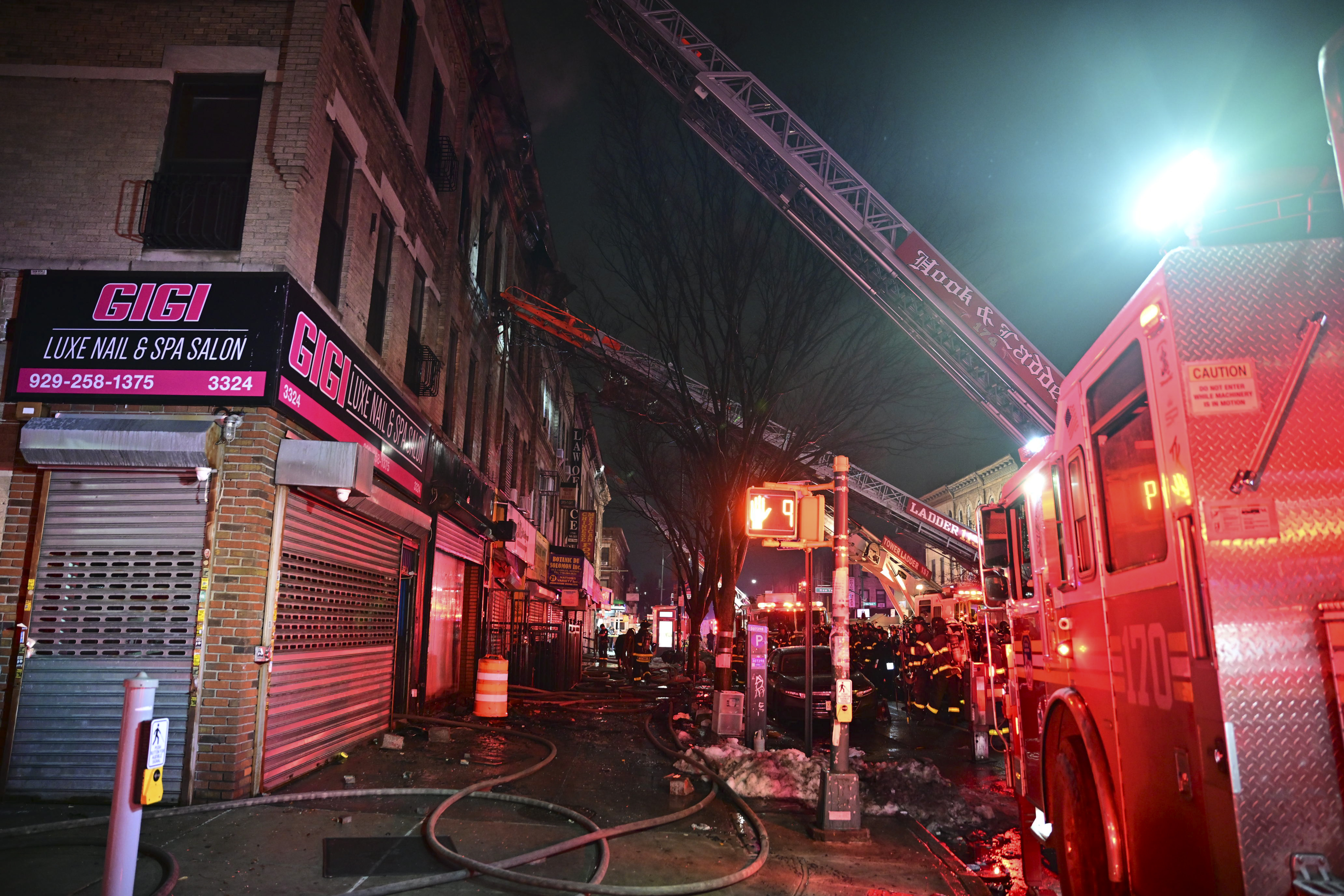 A firefighter is covered in soot and ash after operating at a three alarm fire in Brooklyn on Feb. 20, 2026.