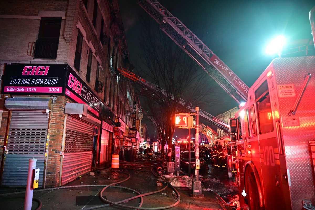 A firefighter is covered in soot and ash after operating at a three alarm fire in Brooklyn on Feb. 20, 2026.