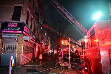 A firefighter is covered in soot and ash after operating at a three alarm fire in Brooklyn on Feb. 20, 2026.