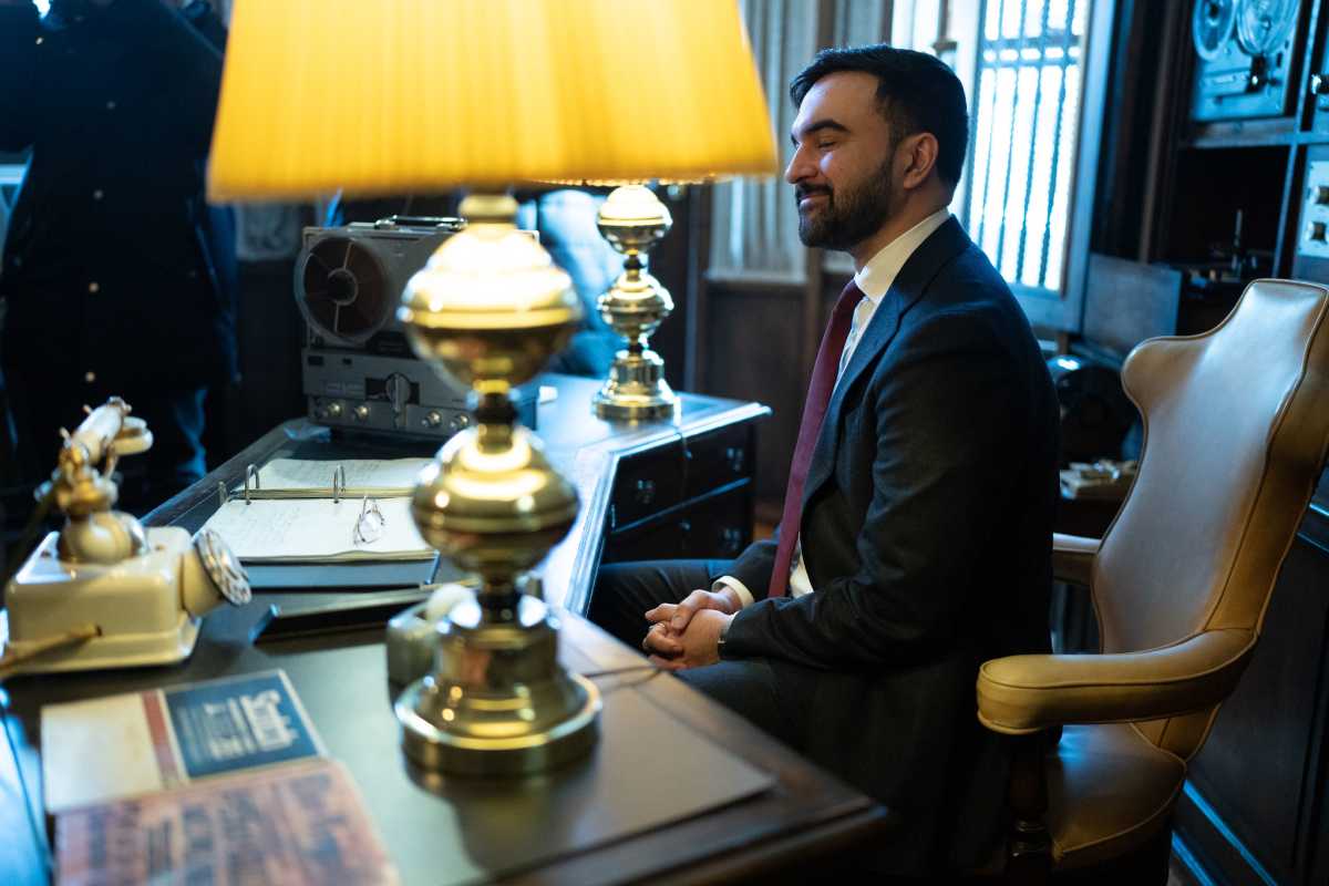 man in a suit sitting at a desk
