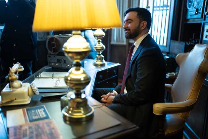 man in a suit sitting at a desk