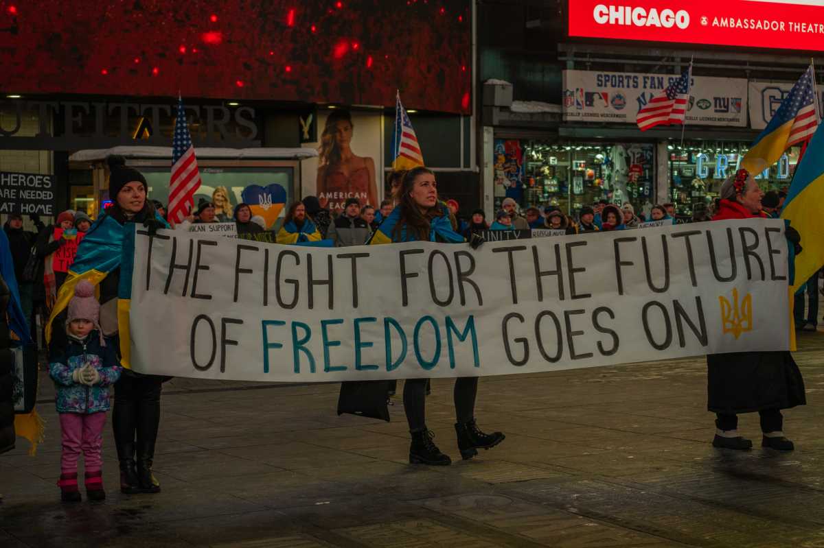 sign in support of Ukraine at ceremony honoring anniversary of invasion by Russia