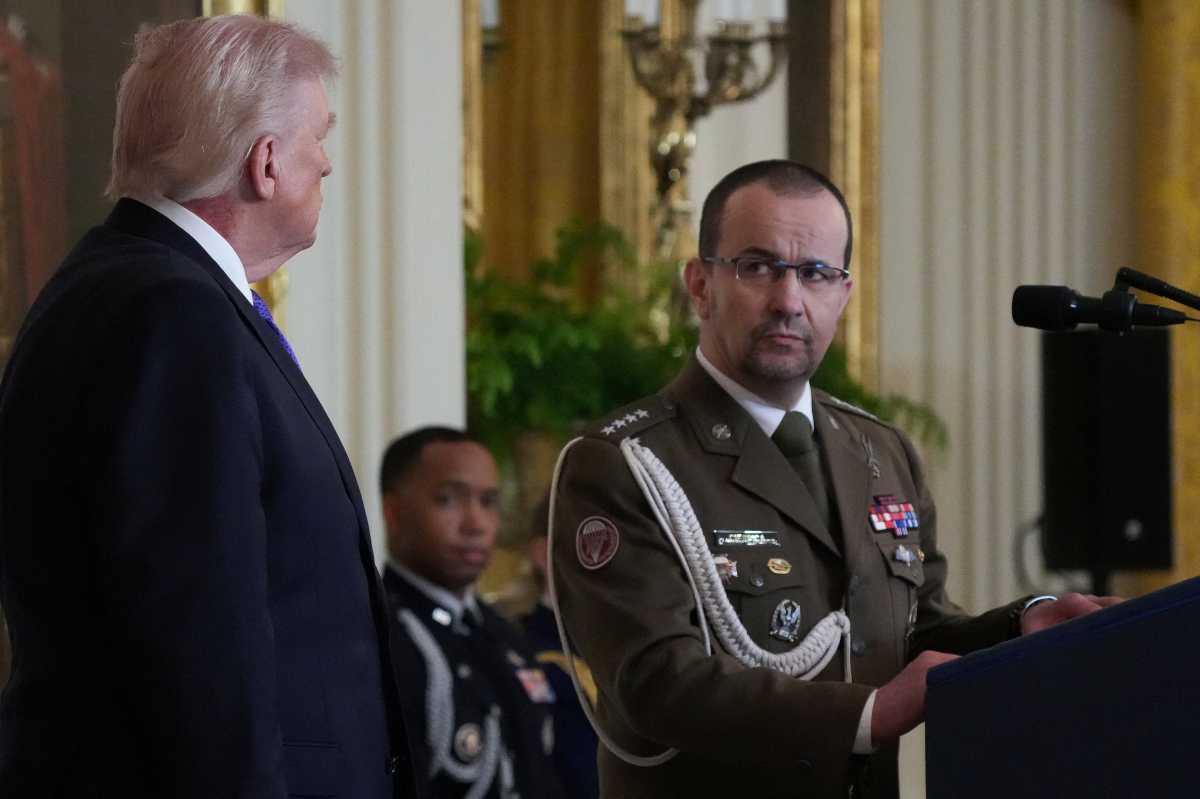 Polish soldier Karol Cierpica, saved in Afghanistan in August 2013 by posthumous honoree U.S. Army Staff Sergeant Michael Ollis, speaks while standing next to U.S. President Donald Trump during a Medal of Honor ceremony held at the White House in Washington, D.C., U.S., March 2, 2026. 