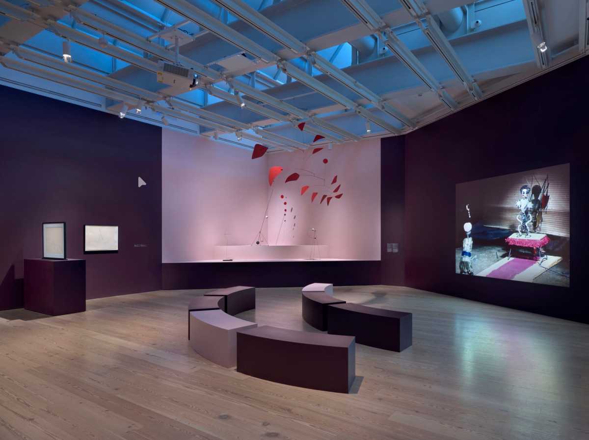 Installation view of High Wire: Calder’s Circus at 100 (Whitney Museum of American Art, New York, October 18, 2025–March 9, 2026). From left to right: Alexander Calder, Two Acrobats, 1932; Alexander Calder, Lone Pole, 1932; Alexander Calder, Sphérique I, 1931; Alexander Calder, Object with Red Discs, 1931; Alexander Calder, Big Red, 1959; Alexander Calder, Little Ball with Counterweight, c. 1931; Projection: Carlos Vilardebó, Le Cirque Calder, 1961. © 2026 Calder Foundation, New York / Artists Rights Society (ARS), New York. Photograph by Ron