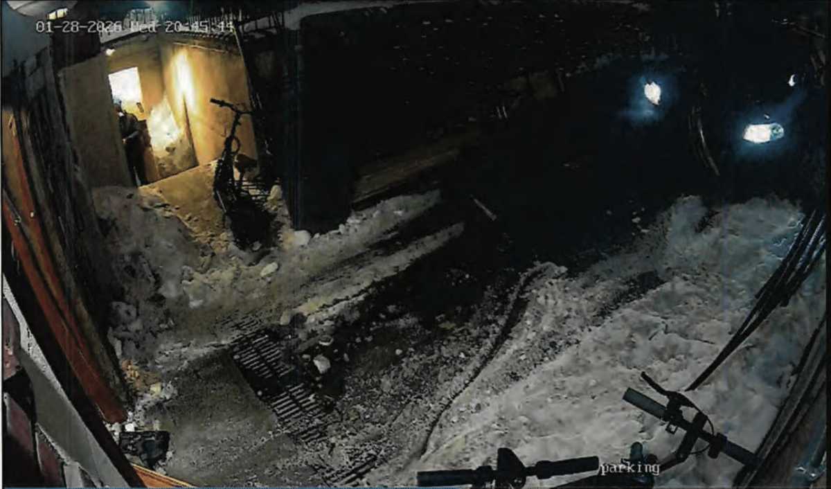 A still image taken from video footage shows the entrance door to Chabad Lubavitch World Headquarters in Brooklyn knocked off its hinges.