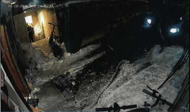 A still image taken from video footage shows the entrance door to Chabad Lubavitch World Headquarters in Brooklyn knocked off its hinges.