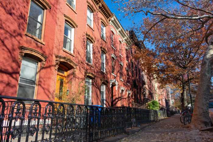 Op-Ed | Our homes are not political leverage 1 A row of colorful old brick homes along the sidewalk in Greenpoint Brooklyn New York during autumn